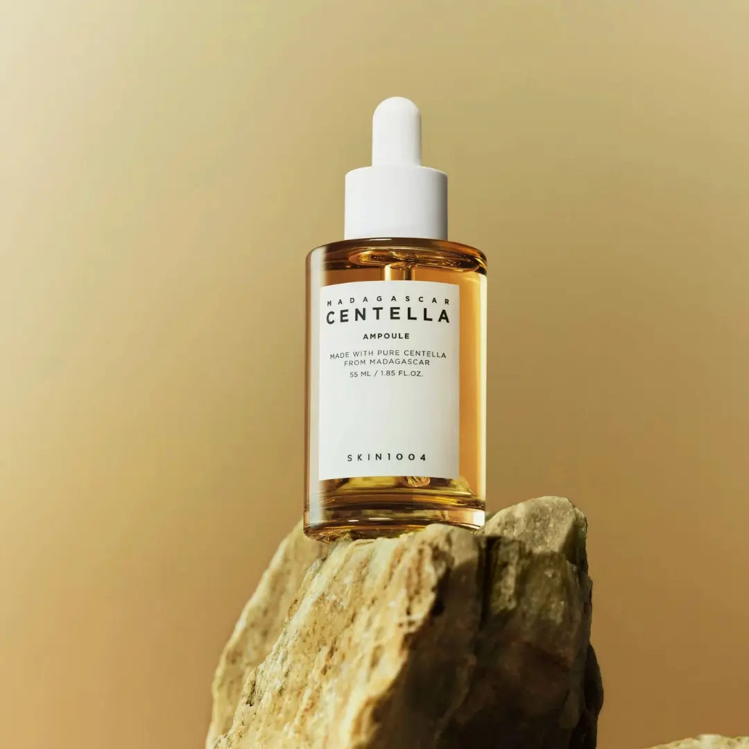 Close-up of SKIN1004 Centella dropper applying serum